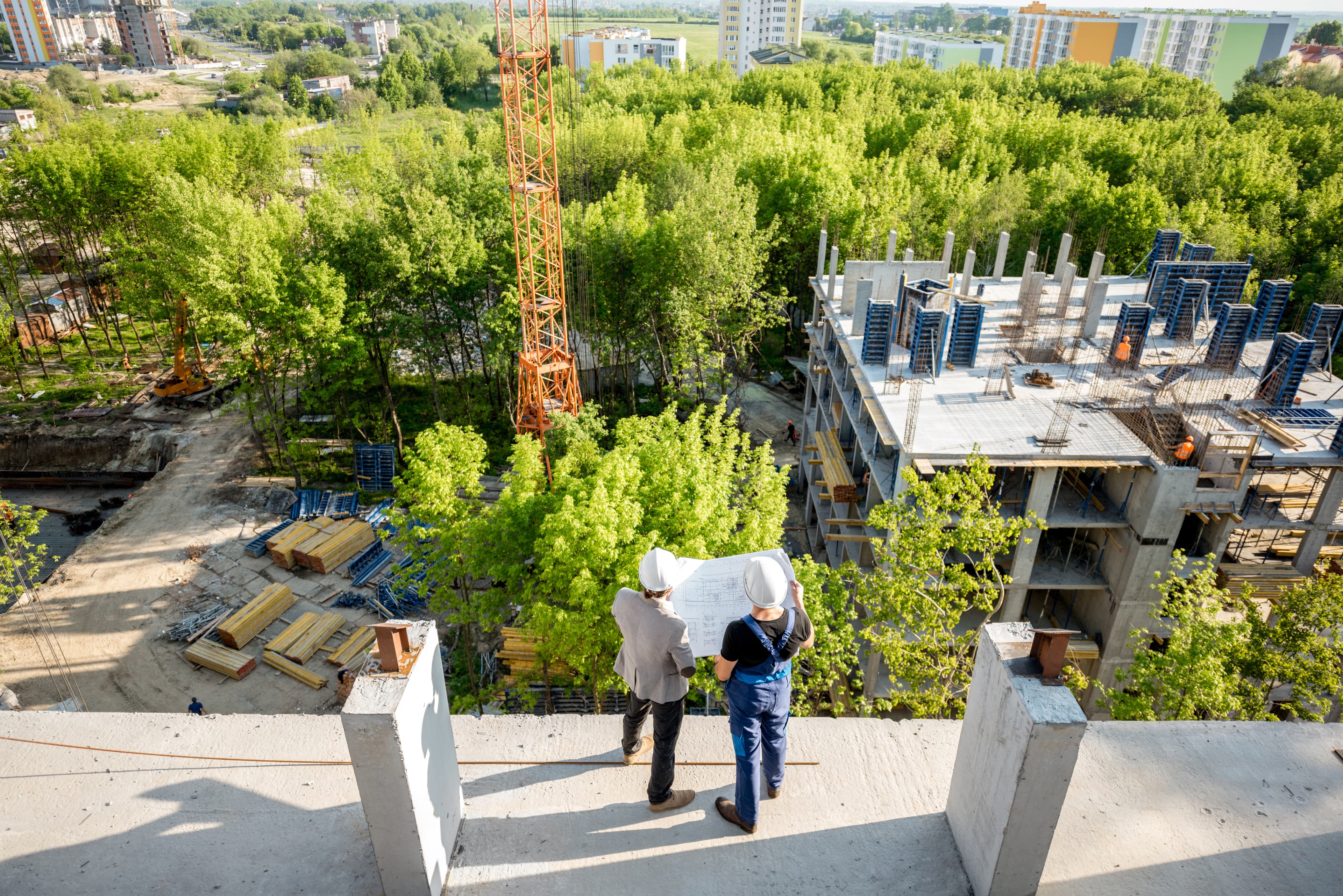 Builders looking at a construction site blueprint